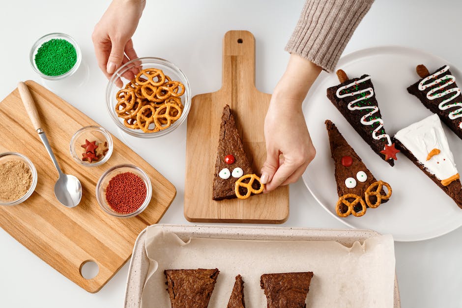 Top View of a Person Decorating a Triangle Shaped Cake